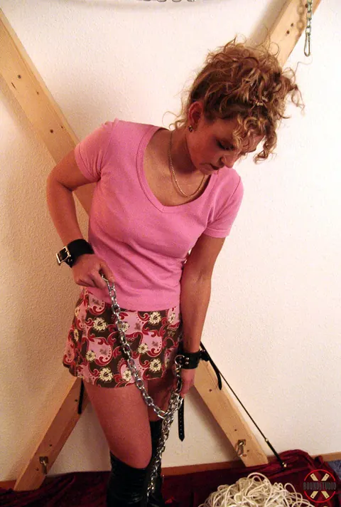 Blonde in Boots and Skirt Restrained on a Cross – photo 8 of 16
