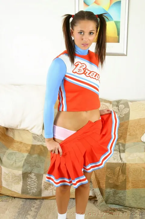 Woman in a Short Skirt and Uniform Poses in Panties – photo 10 of 21
