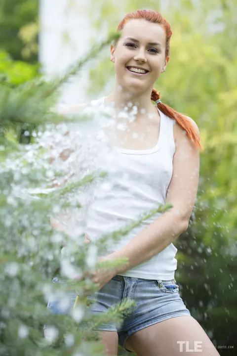 Charlie Red: Pale Redhead in Shorts Soaks Herself with Hose Outdoors – photo 2 of 16