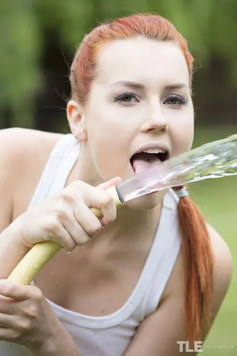 Charlie Red: Pale Redhead in Shorts Soaks Herself with Hose Outdoors – photo 4 of 16