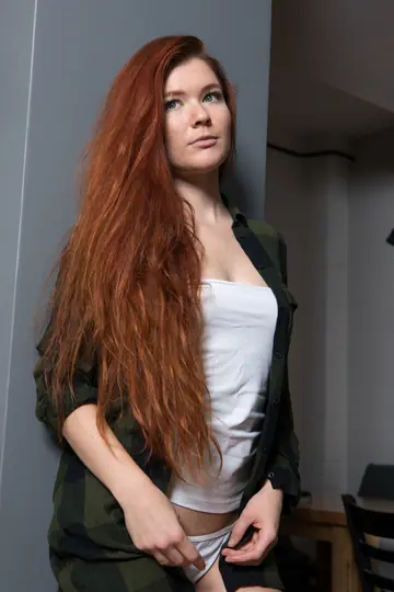 Redhead Reveals Her Small Tits and Shaved Pussy