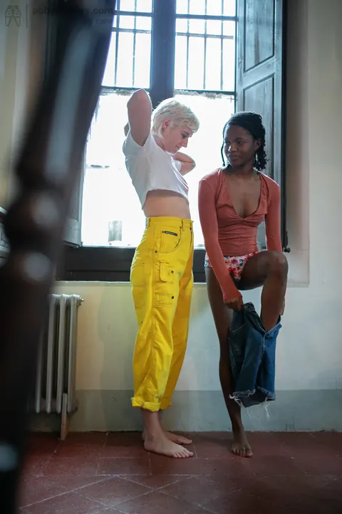 Mae Lynn: Short-Haired Blonde and Ebony Woman Kiss by the Window – photo 16 of 21