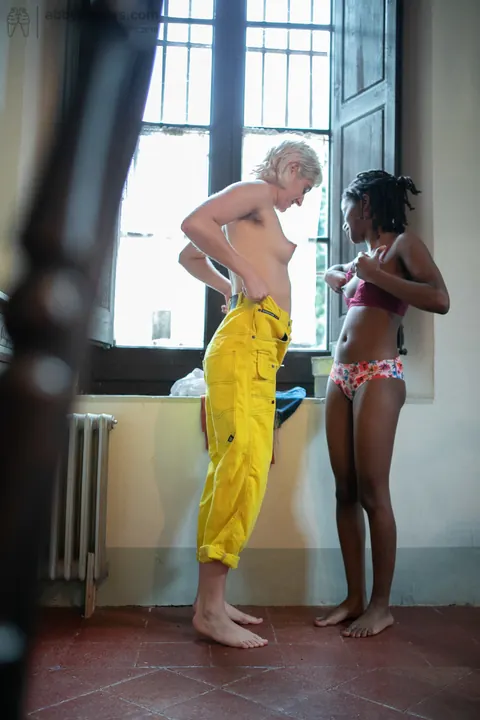 Mae Lynn: Short-Haired Blonde and Ebony Woman Kiss by the Window – photo 12 of 21