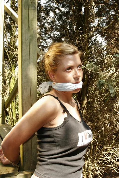 Blonde Tied to a Wooden Frame in the Forest – photo 14 of 17