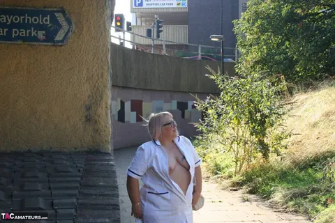 Lexie Cummings: Mature Blonde Nurse in Glasses Strips Naked on Sidewalk – photo 8 of 19
