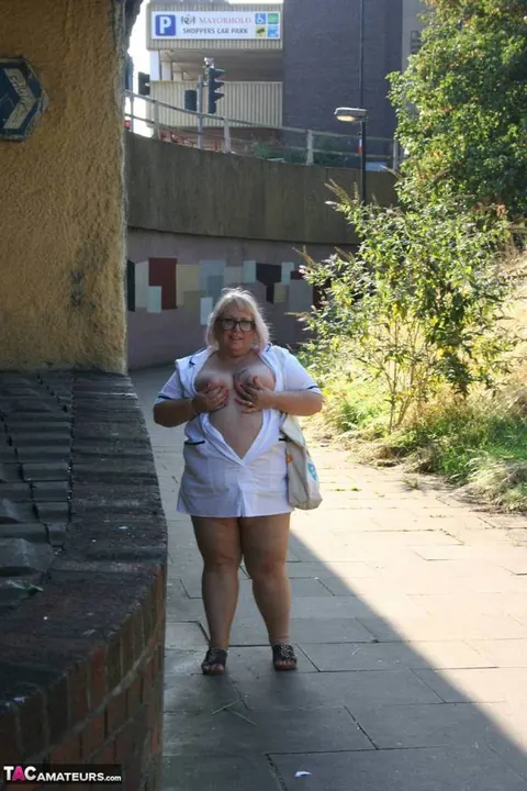 Lexie Cummings: Mature Blonde Nurse in Glasses Strips Naked on Sidewalk – photo 5 of 19