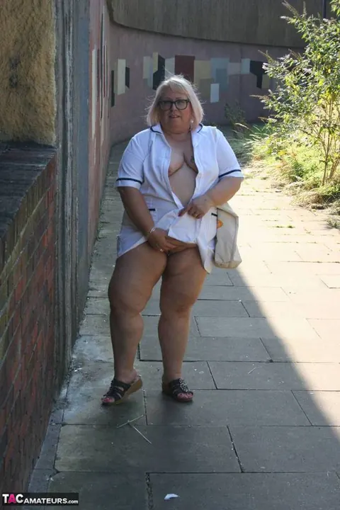 Lexie Cummings: Mature Blonde Nurse in Glasses Strips Naked on Sidewalk – photo 9 of 19