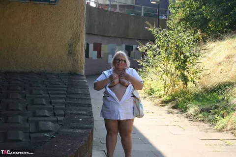Lexie Cummings: Mature Blonde Nurse in Glasses Strips Naked on Sidewalk – photo 7 of 19