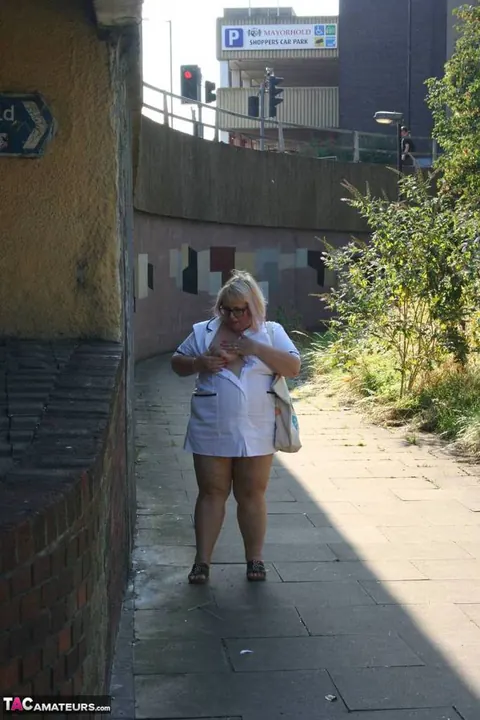 Lexie Cummings: Mature Blonde Nurse in Glasses Strips Naked on Sidewalk – photo 3 of 19