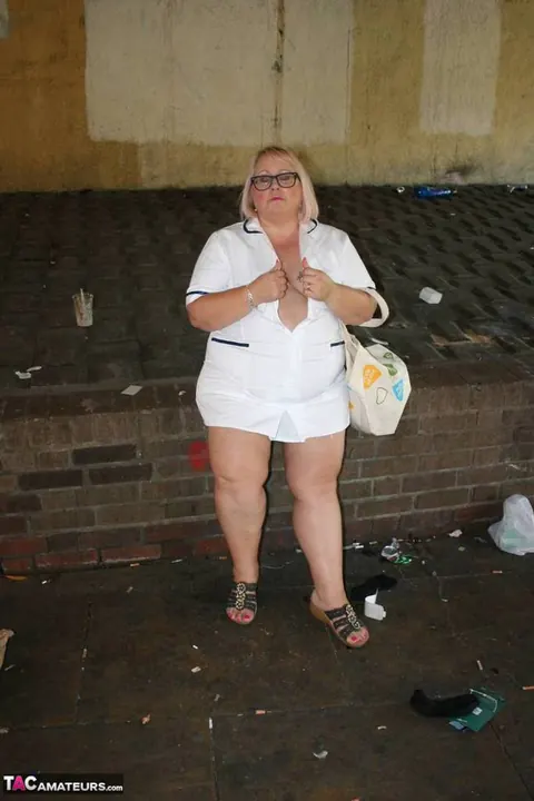 Lexie Cummings: Mature Blonde Nurse in Glasses Strips Naked on Sidewalk – photo 10 of 19