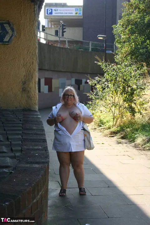 Lexie Cummings: Mature Blonde Nurse in Glasses Strips Naked on Sidewalk – photo 6 of 19