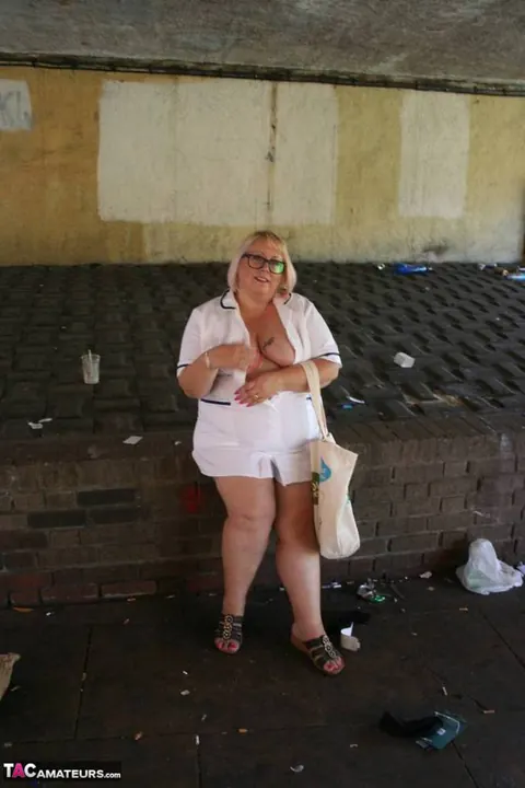 Lexie Cummings: Mature Blonde Nurse in Glasses Strips Naked on Sidewalk – photo 11 of 19