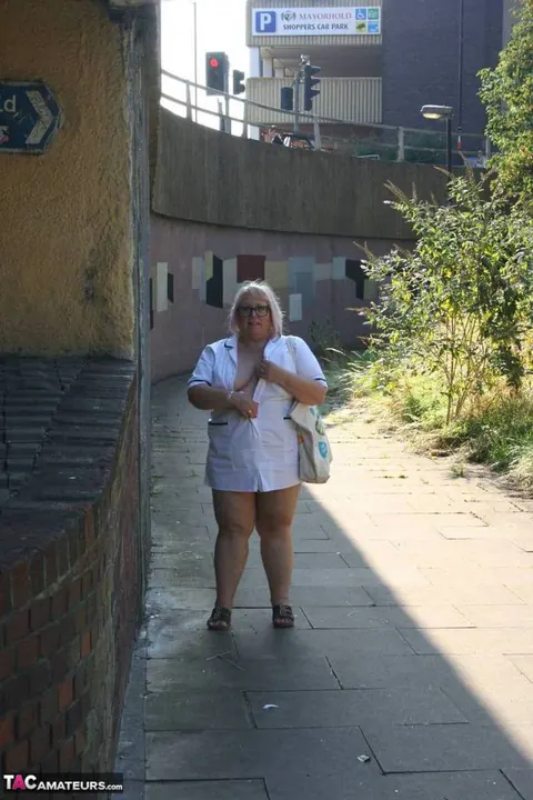 Lexie Cummings: Mature Blonde Nurse in Glasses Strips Naked on Sidewalk – photo 4 of 19