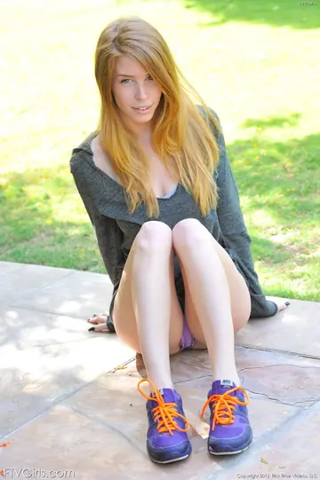 Slim Redhead Undresses in the Garden and Uses a Dildo