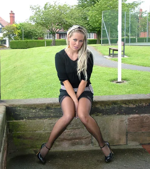 Blonde Shows Off Her Stocking Legs in Heels on a Brick Porch – photo 8 of 16