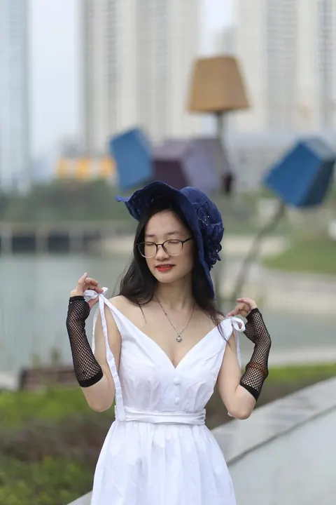 Asian Woman in Glasses and a Skirt Poses Outdoors – photo 3 of 21