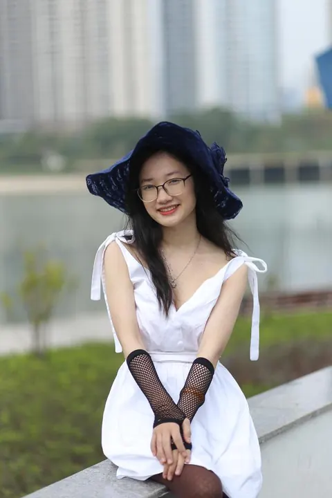 Asian Woman in Glasses and a Skirt Poses Outdoors – photo 14 of 21