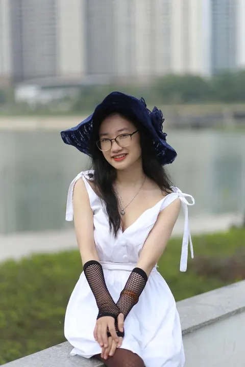 Asian Woman in Glasses and a Skirt Poses Outdoors – photo 13 of 21