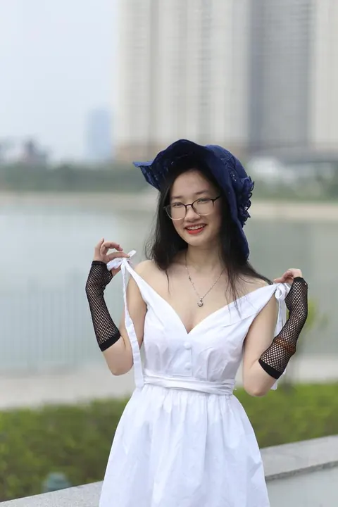 Asian Woman in Glasses and a Skirt Poses Outdoors – photo 6 of 21