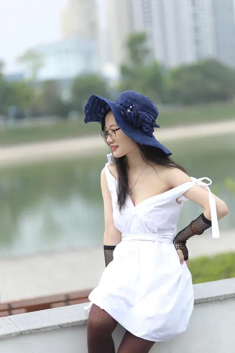 Asian Woman in Glasses and a Skirt Poses Outdoors – photo 16 of 21