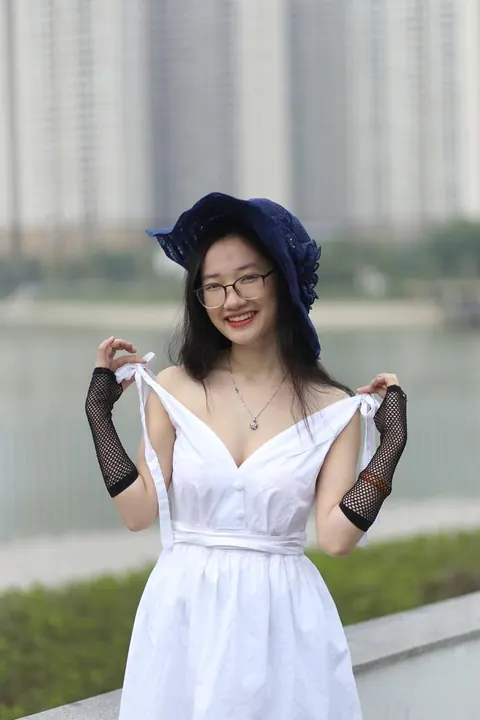 Asian Woman in Glasses and a Skirt Poses Outdoors – photo 7 of 21