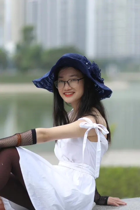 Asian Woman in Glasses and a Skirt Poses Outdoors – photo 19 of 21