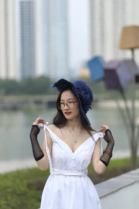 Asian Woman in Glasses and a Skirt Poses Outdoors – photo 5 of 21