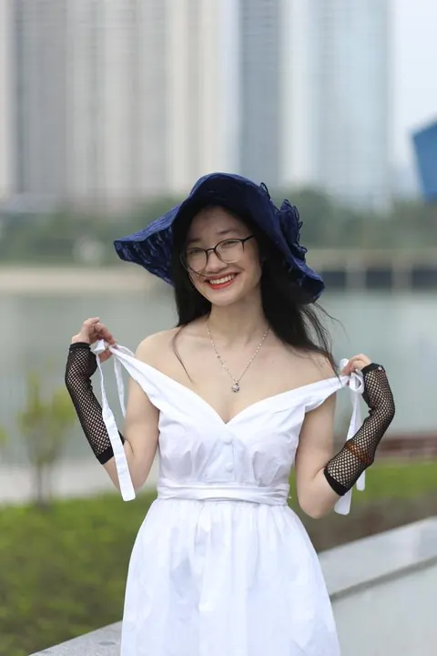 Asian Woman in Glasses and a Skirt Poses Outdoors – photo 10 of 21
