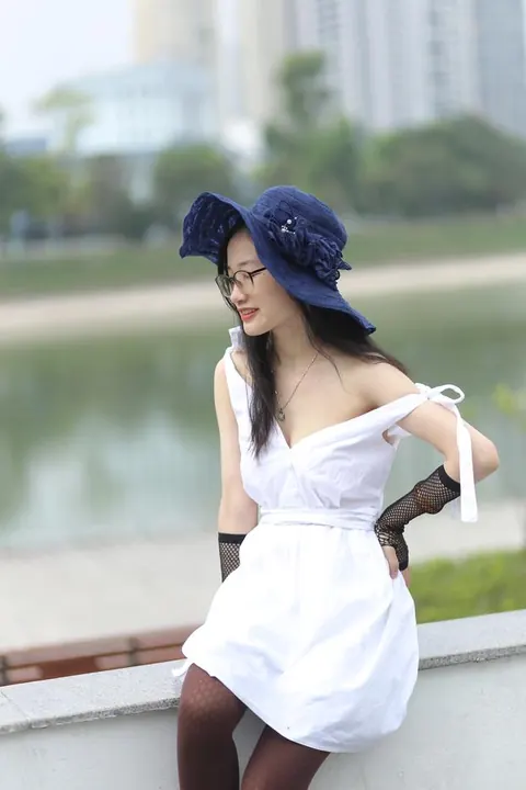 Asian Woman in Glasses and a Skirt Poses Outdoors – photo 15 of 21