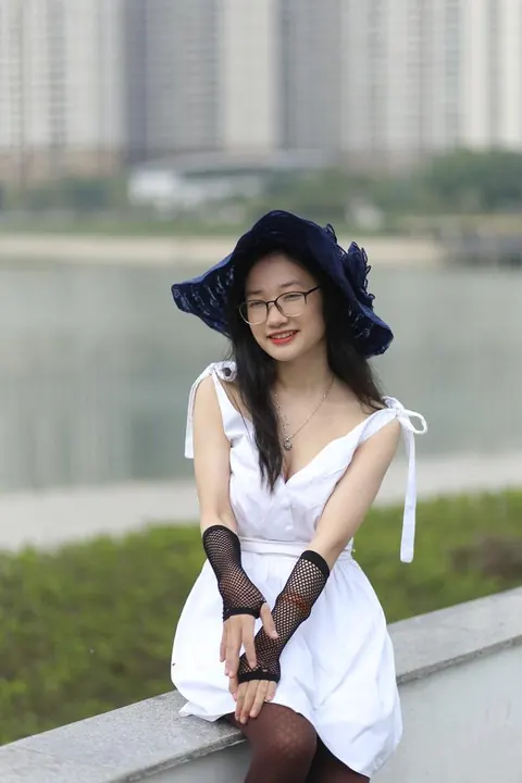 Asian Woman in Glasses and a Skirt Poses Outdoors – photo 11 of 21