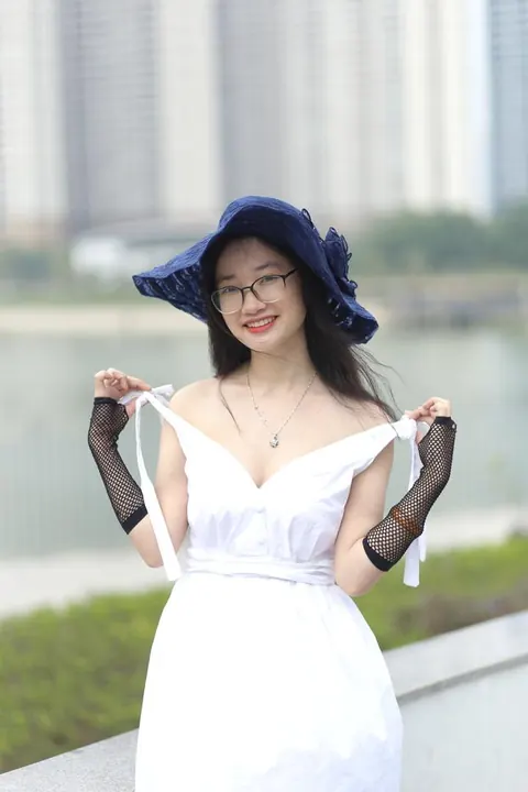 Asian Woman in Glasses and a Skirt Poses Outdoors – photo 8 of 21