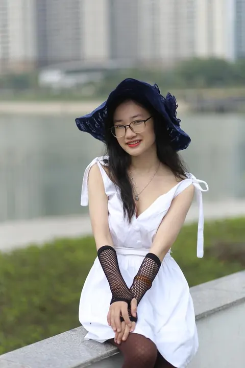 Asian Woman in Glasses and a Skirt Poses Outdoors – photo 12 of 21