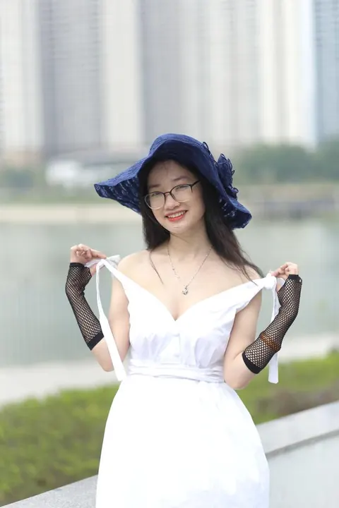 Asian Woman in Glasses and a Skirt Poses Outdoors – photo 9 of 21