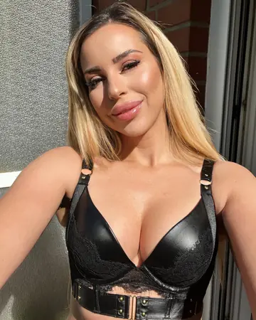 Busty Blonde in Latex and Boots Shows Off Her Curves