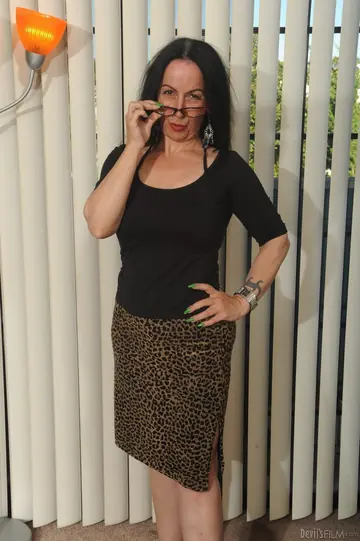 Busty Mature Brunette Poses in Lingerie and Skirt