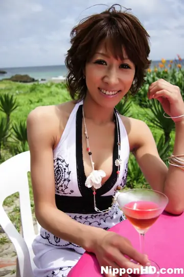 Japanese Brunette with Big Tits Shows Cleavage in a Skirt on the Beach