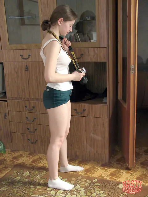 Redhead Peels Off Her Shorts and Socks Before Posing Nude – photo 1 of 20