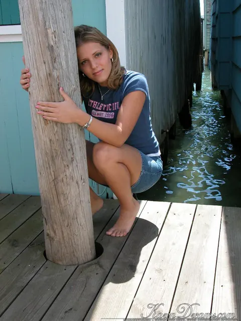 Woman Flashes Her Panties and Spreads Her Legs on a Pier – photo 11 of 12