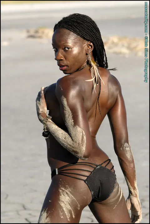 Camille Elizabeth: Athletic Ebony Woman in a Bikini Covers Breasts with Sand Outdoors – photo 14 of 15