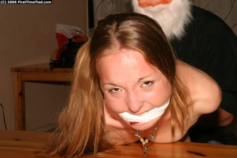 Amateur Woman Handcuffed and Gagged by Santa-Masked Man – photo 9 of 12