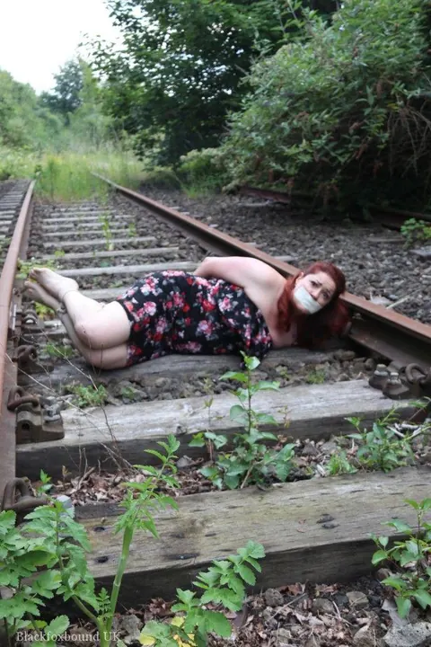 Redhead Bound and Gagged in a Skirt Outdoors – photo 8 of 16