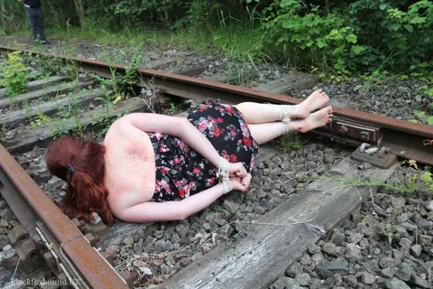Redhead Bound and Gagged in a Skirt Outdoors – photo 3 of 16