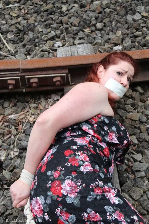 Redhead Bound and Gagged in a Skirt Outdoors – photo 7 of 16