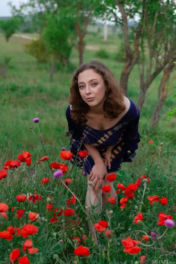 Busty Curly Woman in a Skirt Spreads in the Forest