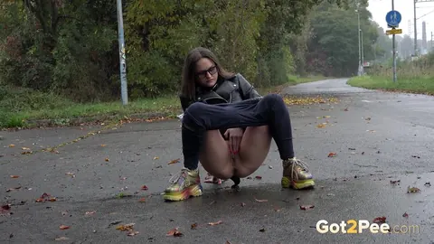 Woman in Glasses Pisses and Spreads on Wet Pavement Outdoors – photo 5 of 15