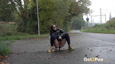 Woman in Glasses Pisses and Spreads on Wet Pavement Outdoors – photo 3 of 15