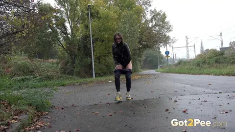 Woman in Glasses Pisses and Spreads on Wet Pavement Outdoors – photo 2 of 15