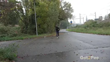 Woman in Glasses Pisses and Spreads on Wet Pavement Outdoors