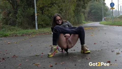 Woman in Glasses Pisses and Spreads on Wet Pavement Outdoors – photo 6 of 15