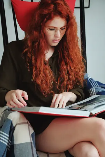 Pale Redhead in Glasses Pulls Panties Aside and Fingers Her Shaved Pussy